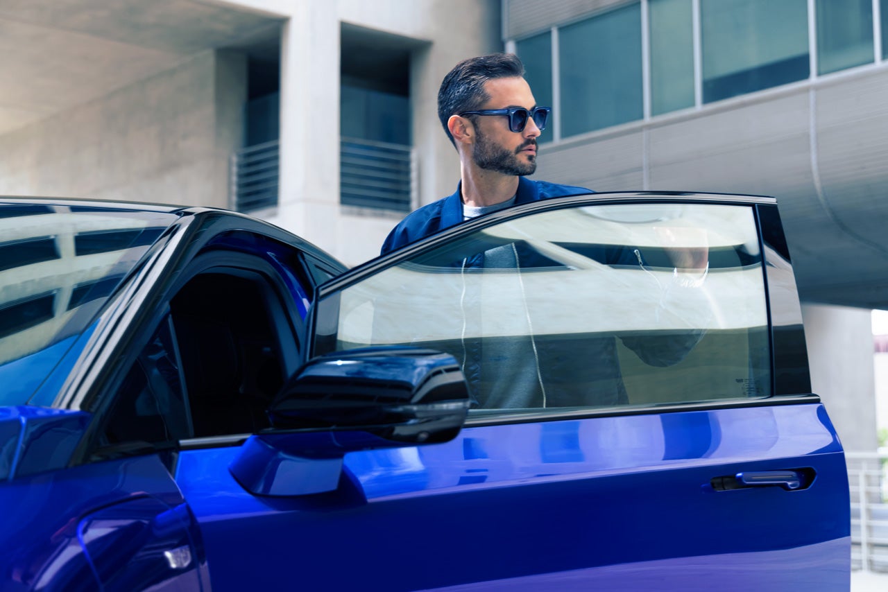 Rear View of the 2025 Cadillac XT4 Driving Fast Through the City at Night